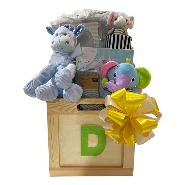 Baby Box designed in a neutral theme and filled with 2 pairs of socks, a plush animal, baby booties, a soft rattle, a onsie, receiving blanket and for mom, chocolate truffles, herbal tea and a box of Cookie It Up shortbread