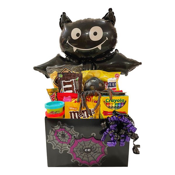 Spooktacular Halloween Gift Basket with Halloween pencil, crayons, playdough, Necco, M & M's, Starburst, Mar's chocolates, caramel popcorn, a spider toy