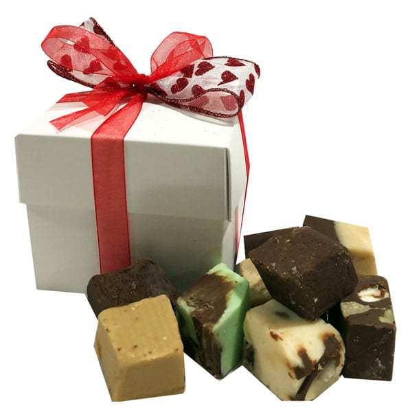 Fudge Sampler gift box filled with 8 fudge bites equal to about half a pound of fudge. Accented with white and red heart ribbon for a little bit of love and romance.